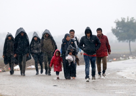 A group of migrants walk on the road near a border line between Serbia and Croatia, near the village of Berkasovo, Serbia, Monday, Oct. 19, 2015. Tension was building among thousands of migrants as they remained stranded in fog and cold weather in the Balkans on Sunday in their quest to reach a better life in Western Europe, two days after Hungary closed its border with Croatia and the flow of people was redirected to a much slower route via Slovenia. (AP Photo/Darko Vojinovic)